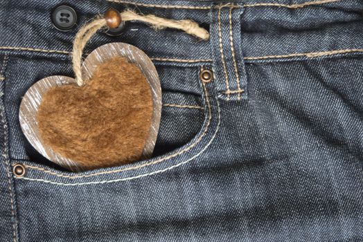 wooden heart in jeans pocket