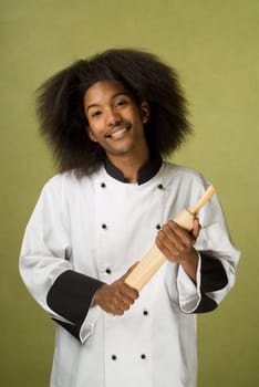 Young Handsome African American Chef Holding Rolling Pin in Hands