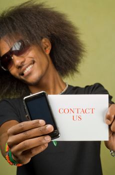 Young Trendy African American Male Holding Card with Cellphone, Contact Us