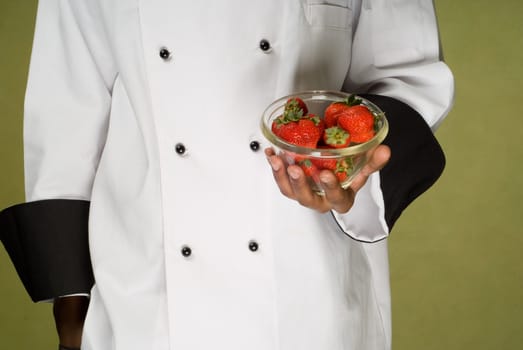 Chef Holding Glass Bowl full of Fresh Organic Strawberries