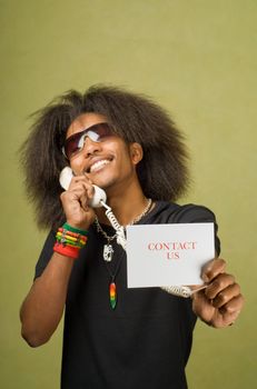 Young Trendy African American Male Holding Card with Phone, Contact Us