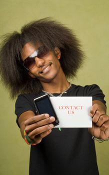 Young Trendy African American Male Holding Card with Cellphone, Contact Us