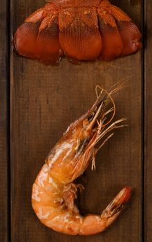 Freshly looked crayfish tail and prawn on wooden table