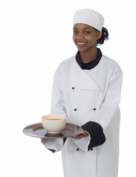 Professional chef in workwear jacket serving soup isoltated on white