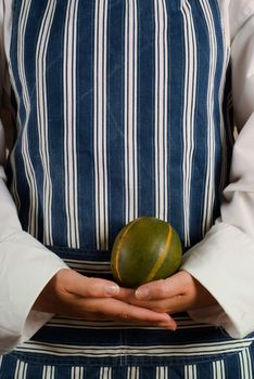 Female woman vegitarian chef or cook holding squash vegetable in her hands