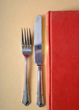 Learn by eating knowledge in book with knife and fork concept
