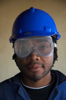 Construction worker plumber with safety goggles mask over eyes