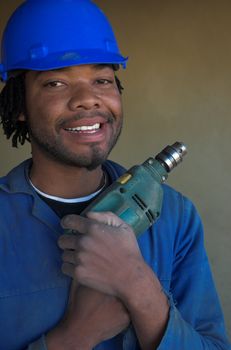 Construction workers hugs his power tool drill