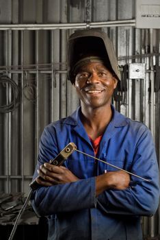South African or American black worker welder in factory