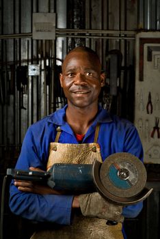 South or African American working with angle grinder