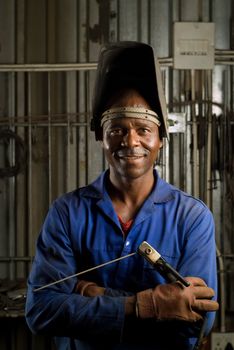 South African or American black worker welder in factory