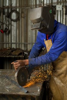 South or African American working with angle grinder