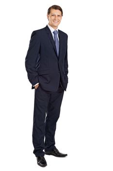 Photo of an attractive businessman smiling with his hands in his pockets.
