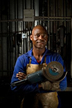 South or African American working with angle grinder