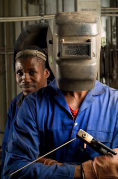 South African or American black workers or welders in factory