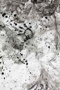 Photo of a mess of ink splatters, droplets, footprints and smears.
