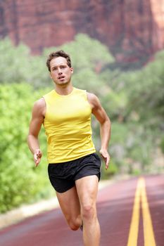 Sport - running fitness man sprinting training for marathon run. Fitness man with determination, concentration and strength training towards goals and success.