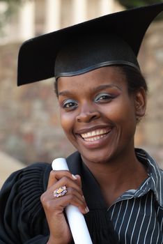 African American College Student Graduating with mortarboard and degree or diploma scroll