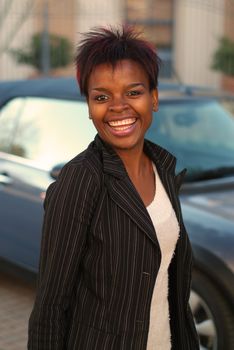 Happy African American businesswoman with new car purchase