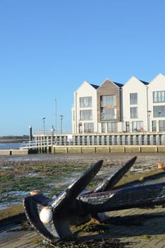 Riverside flats with Anchor in Foreground in portrait format
