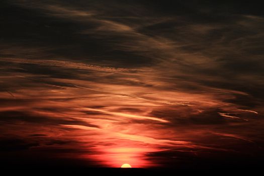 Red sunset sky stormy clouds