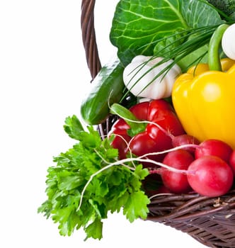 Raw vegetables in a wicker basket isolated on white background