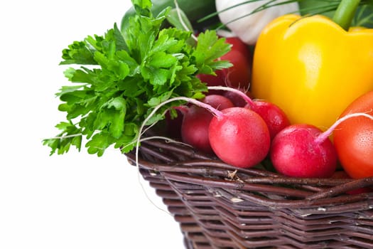 Fresh vegetables in a wicker basket. Isolated on white background. Copy space