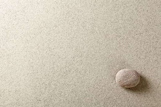 Beige stone at right side of sand background
