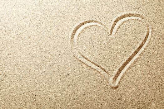 Heart drawn in the sand. Beach background. Top view