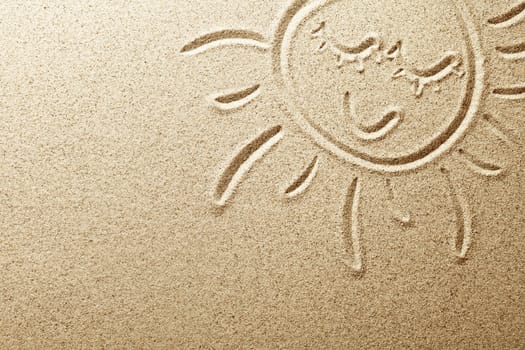 Sun drawn in the sand. Beach background. Top view