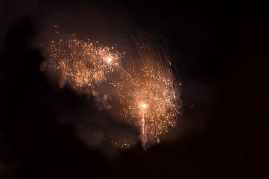 Orange fireworks in the night sky at the celebration of New year in Krivoi Rog