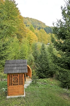 Fountain in a mountain garden surrounded by pines