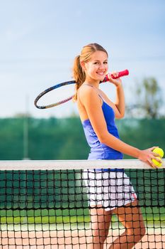 Portrait of a pretty young tennis player with copyspace