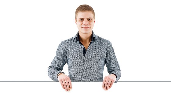 smiling young man with a white poster