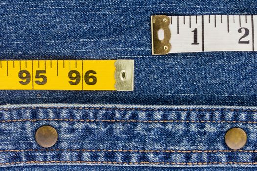 Close-up photograph of measuring tape on denim material.