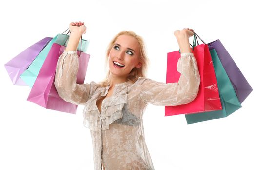 Young beautiful caucasian woman holds colorful shopping bags in her hands and smiling isolated over white background