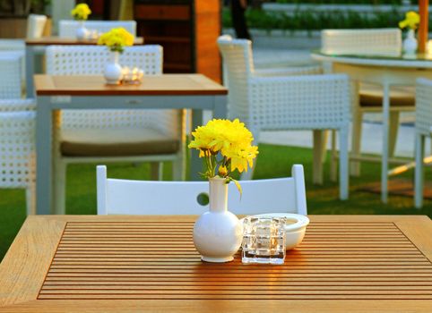 Table and chair setting with flower in outdoor restaurant