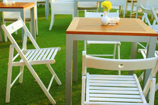 Table and chair setting with flower in outdoor restaurant