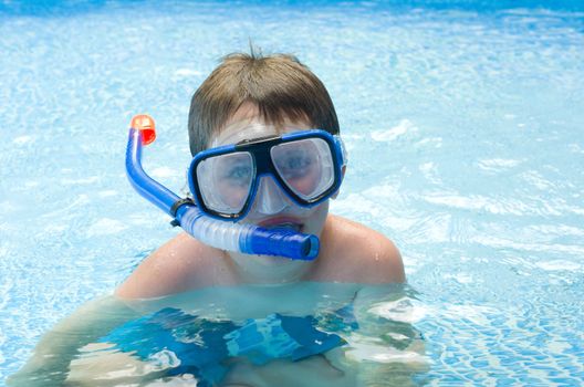 Boy swimming in snorkel in pool