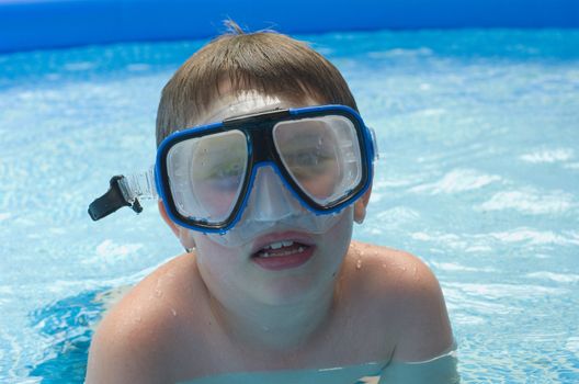 Boy in pool with diving mask