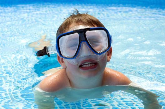 Boy in pool with diving mask