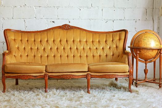 Vintage furniture sofa with old globe