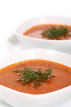 Image of two bowls of hot red soup isolated on white background