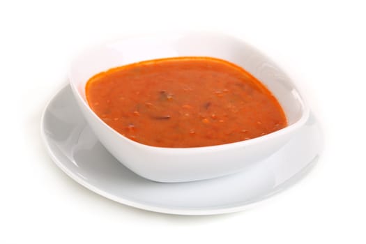 Image of bowl of hot red soup isolated on white background