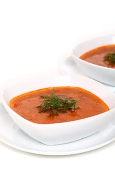 Image of two bowls of hot red soup isolated on white background