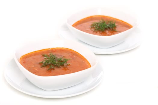 Image of two bowls of hot red soup isolated on white background