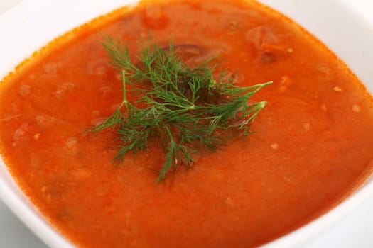 Image of bowl of hot red soup isolated on white background