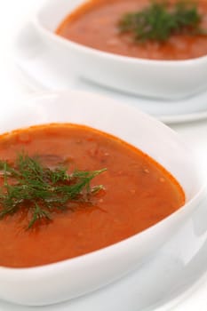 Image of two bowls of hot red soup isolated on white background