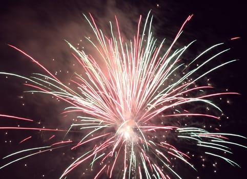 bright holiday fireworks in night sky