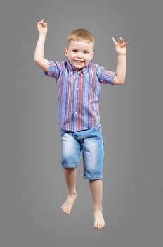 boy jumping hands up smiling and happy